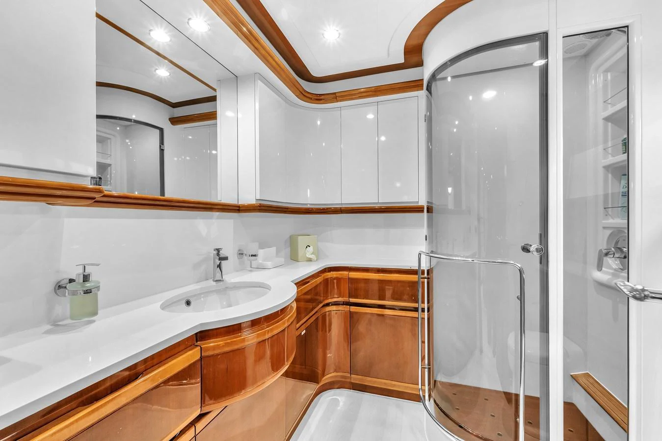 The yacht's bathroom features elegant wood accents and a modern shower enclosure. aboard FERRETTI YACHTS CUSTOM LINE 94 Yacht for Sale