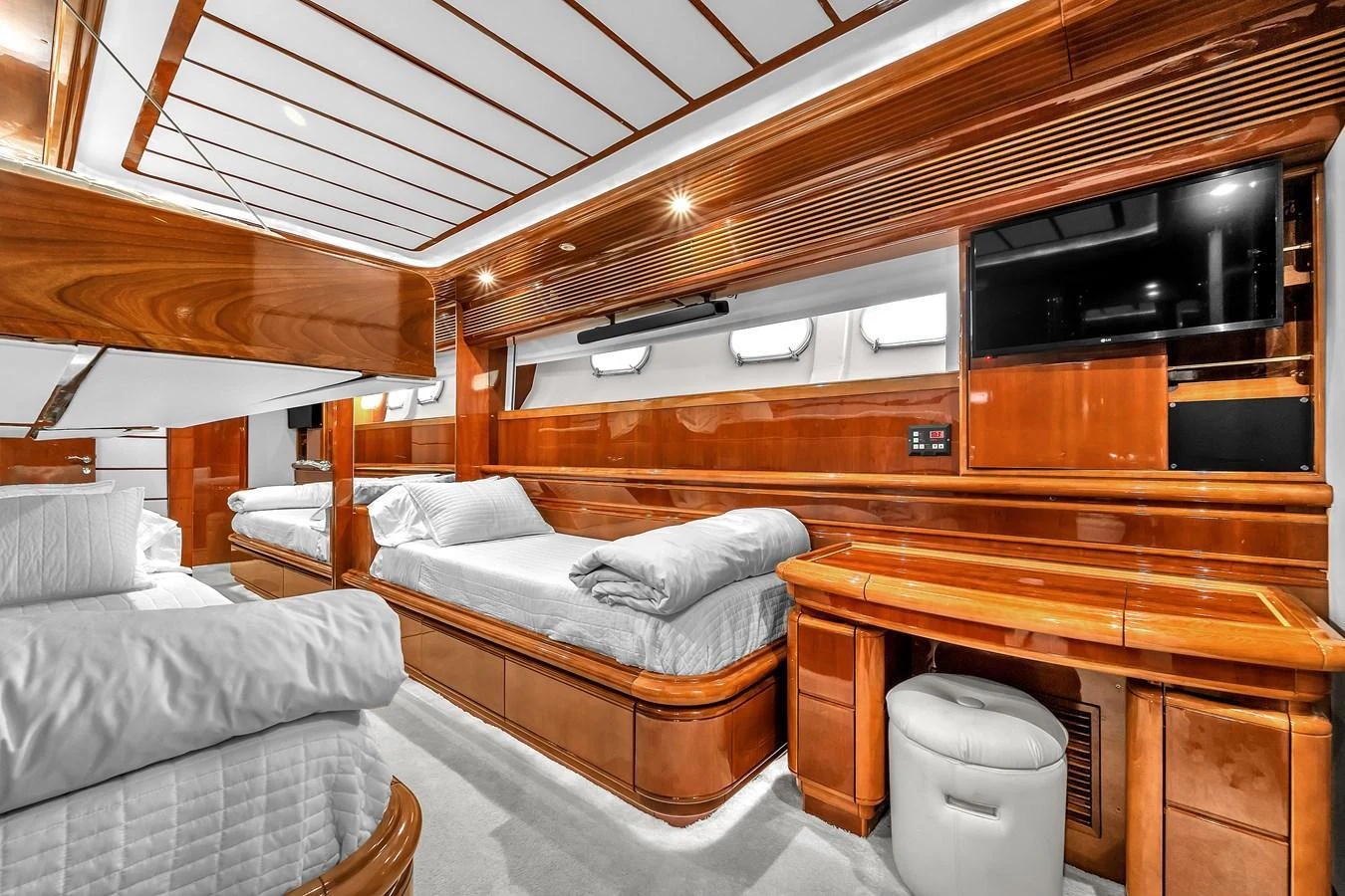 The guest cabin features luxurious wooden finishes and comfortable bedding, creating a warm and inviting atmosphere. aboard FERRETTI YACHTS CUSTOM LINE 94 Yacht for Sale