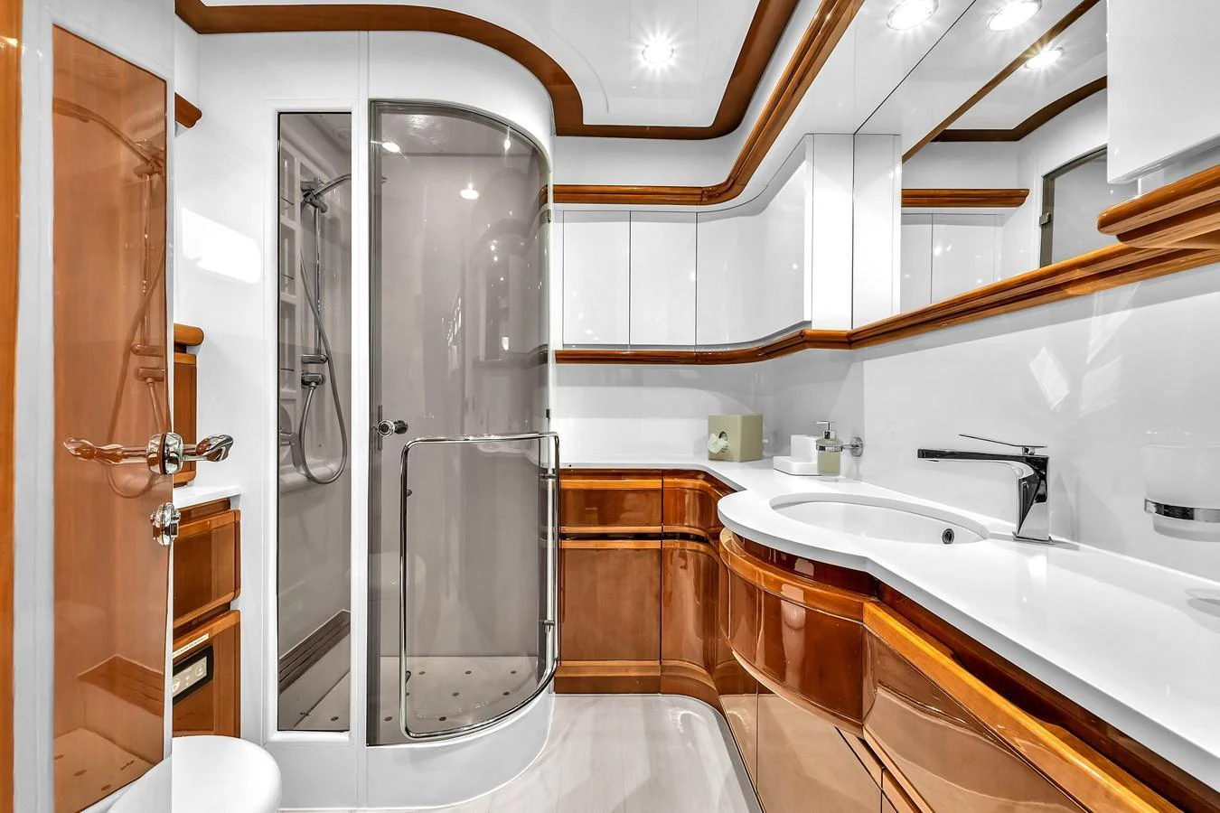 The yacht's bathroom features elegant wood accents and modern fixtures, creating a luxurious and sophisticated space. aboard FERRETTI YACHTS CUSTOM LINE 94 Yacht for Sale