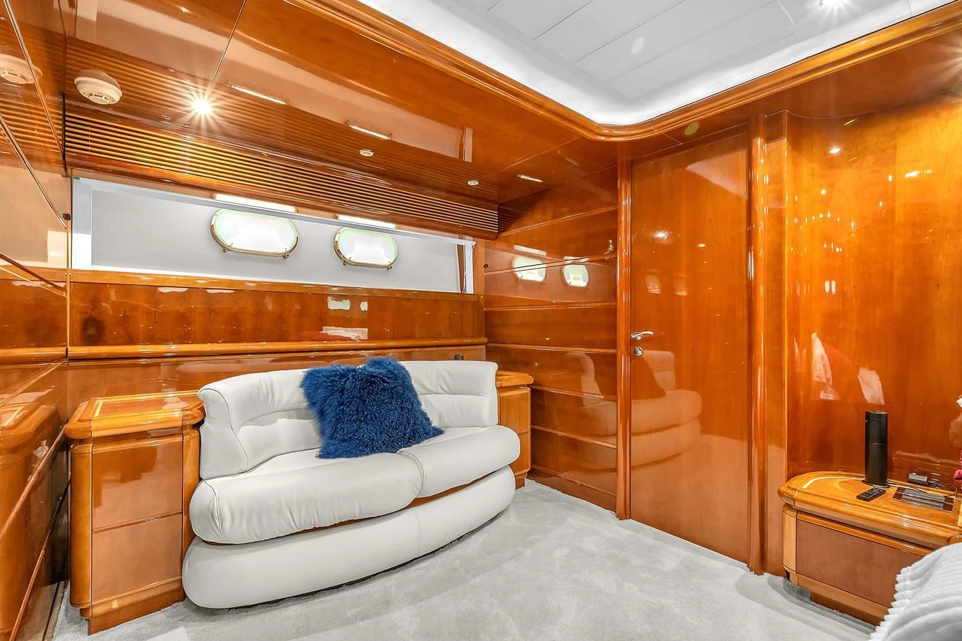 The yacht's interior features a cozy seating area with luxurious wooden paneling and plush furnishings. aboard FERRETTI YACHTS CUSTOM LINE 94 Yacht for Sale