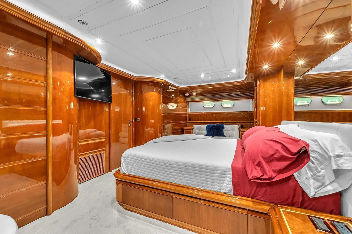 The master stateroom features luxurious wood paneling and a spacious bed with elegant bedding. aboard FERRETTI YACHTS CUSTOM LINE 94 Yacht for Sale