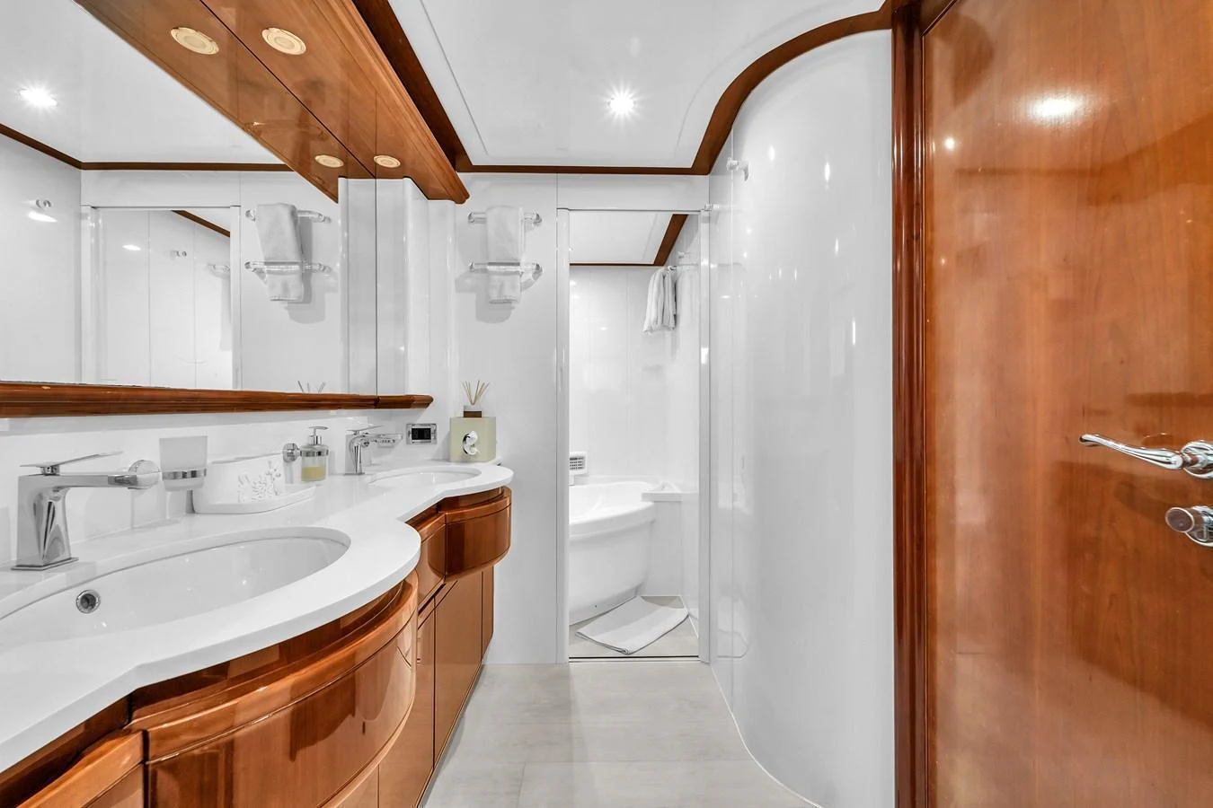 The yacht's bathroom features elegant wood accents and modern fixtures. aboard FERRETTI YACHTS CUSTOM LINE 94 Yacht for Sale