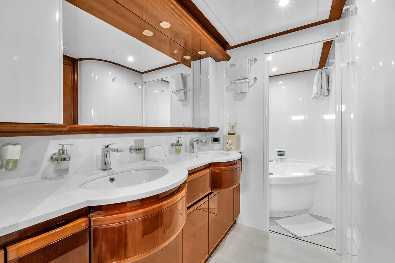 The yacht's bathroom features elegant wooden cabinetry and a spacious, modern design. aboard FERRETTI YACHTS CUSTOM LINE 94 Yacht for Sale