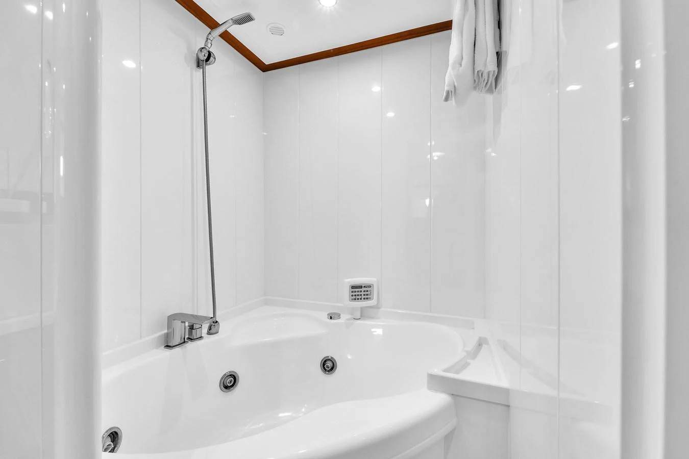 The yacht's bathroom features a luxurious white jacuzzi tub and modern fixtures. aboard FERRETTI YACHTS CUSTOM LINE 94 Yacht for Sale