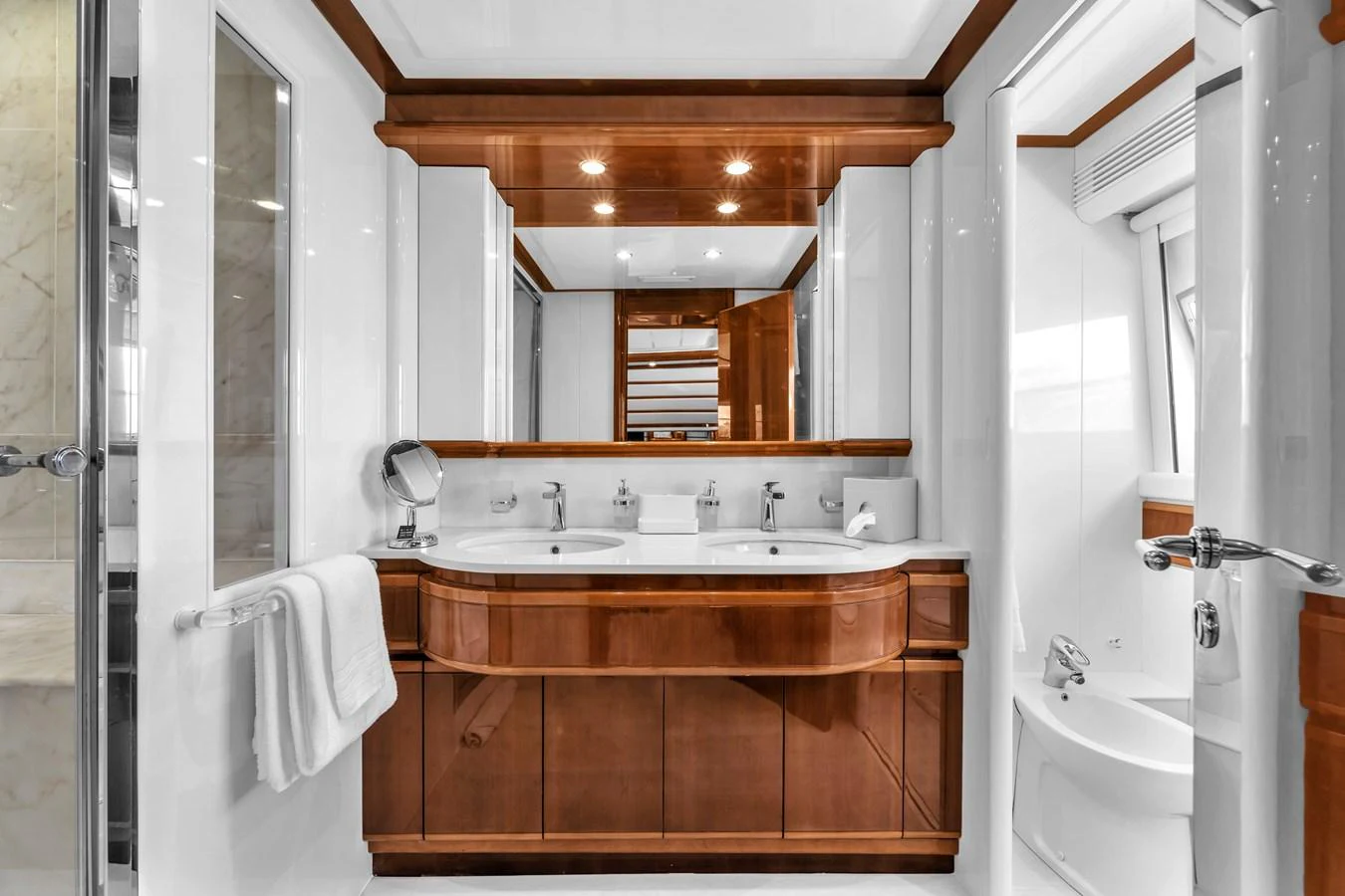 The yacht's bathroom features elegant wood accents and modern fixtures. aboard FERRETTI YACHTS CUSTOM LINE 94 Yacht for Sale