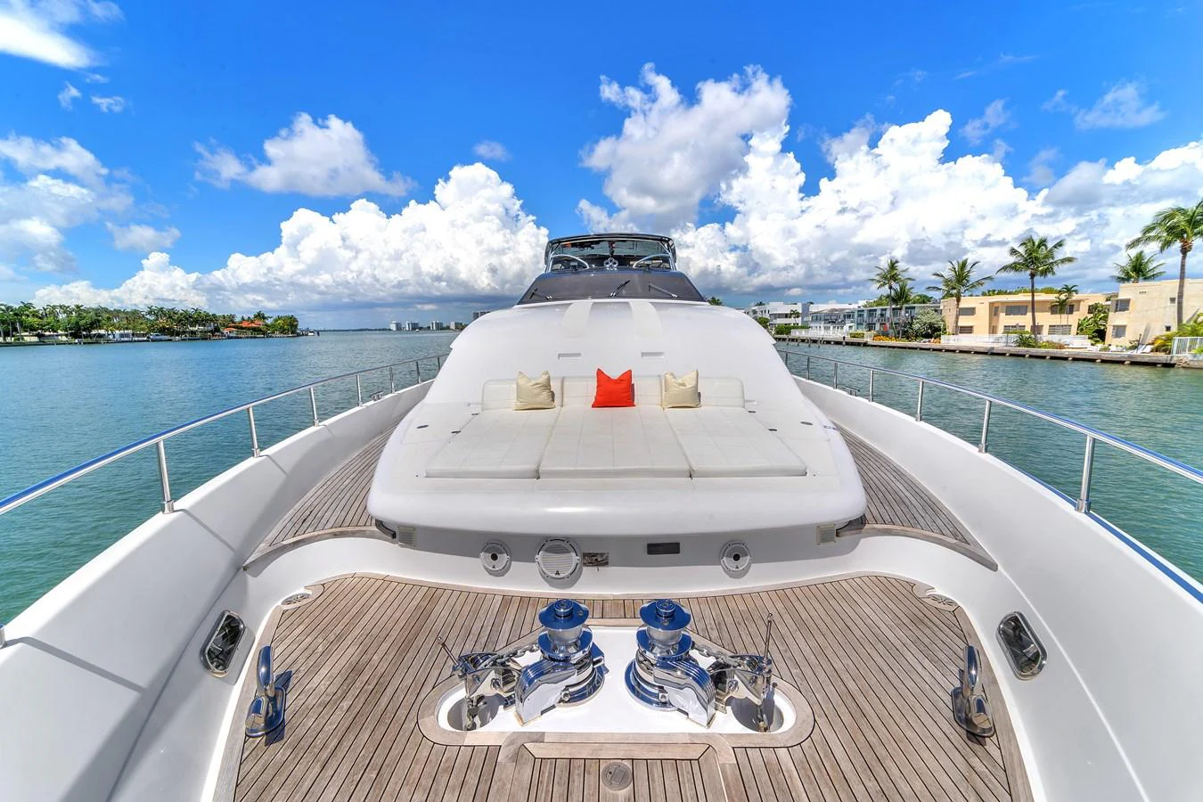 The foredeck features a spacious sunbathing area with plush cushions and a vibrant accent pillow. aboard FERRETTI YACHTS CUSTOM LINE 94 Yacht for Sale