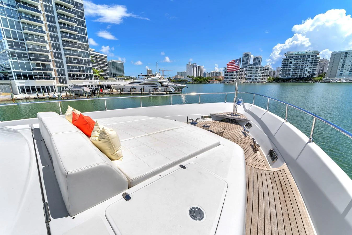 The foredeck offers a spacious sunbathing area with plush cushions, perfect for relaxation while enjoying the waterfront views. aboard FERRETTI YACHTS CUSTOM LINE 94 Yacht for Sale