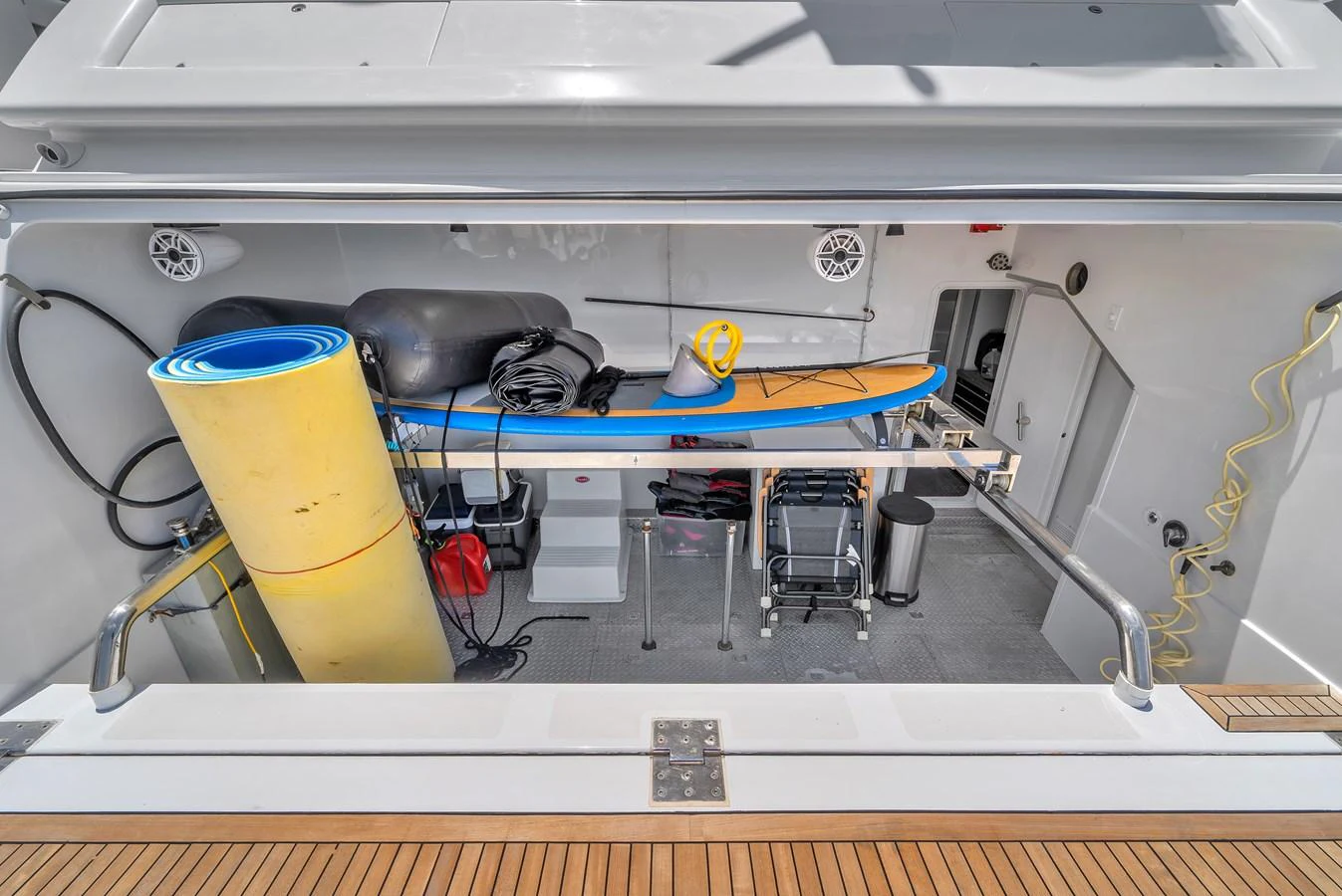 The yacht features a well-organized toy storage area with various water sports equipment. aboard FERRETTI YACHTS CUSTOM LINE 94 Yacht for Sale