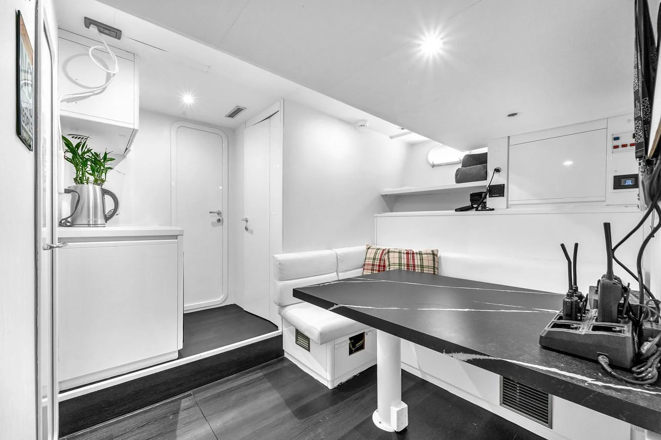 The crew area features a functional and modern design with a small dining table and kitchenette. aboard FERRETTI YACHTS CUSTOM LINE 94 Yacht for Sale