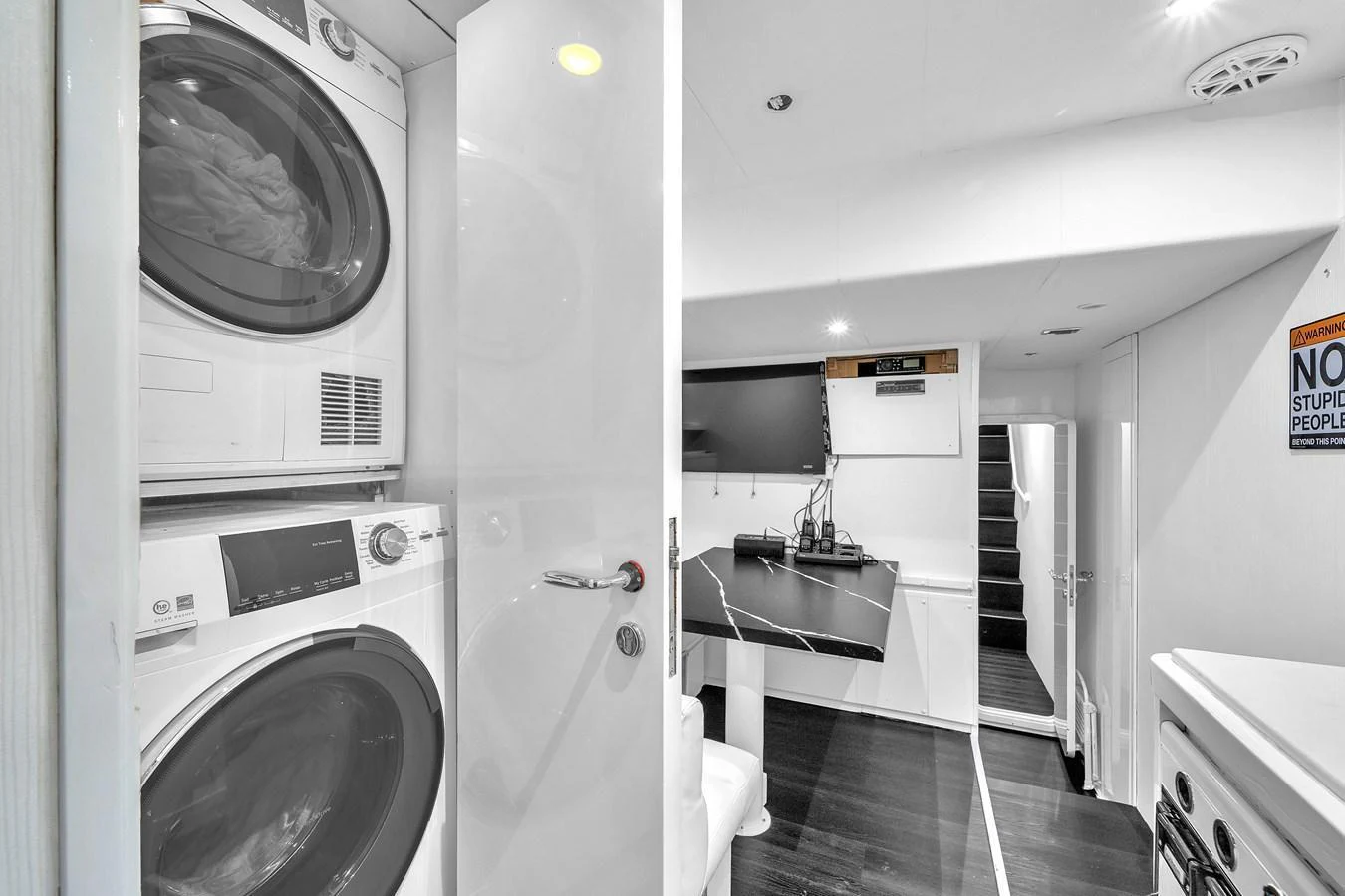 The yacht features a modern and efficient laundry area with stacked washer and dryer units. aboard FERRETTI YACHTS CUSTOM LINE 94 Yacht for Sale