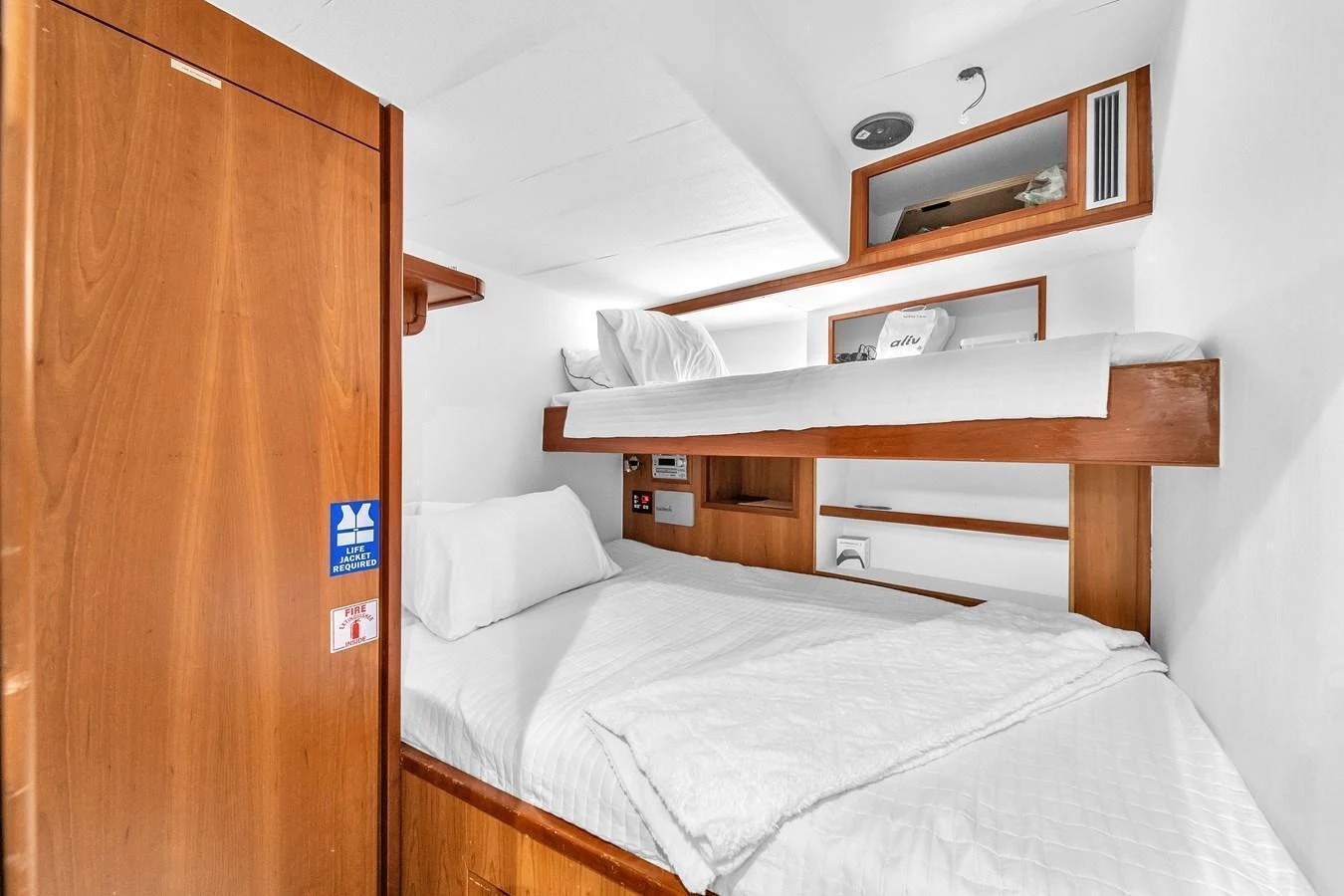 The cozy cabin features wooden furnishings and comfortable bedding, creating a warm and inviting atmosphere. aboard FERRETTI YACHTS CUSTOM LINE 94 Yacht for Sale