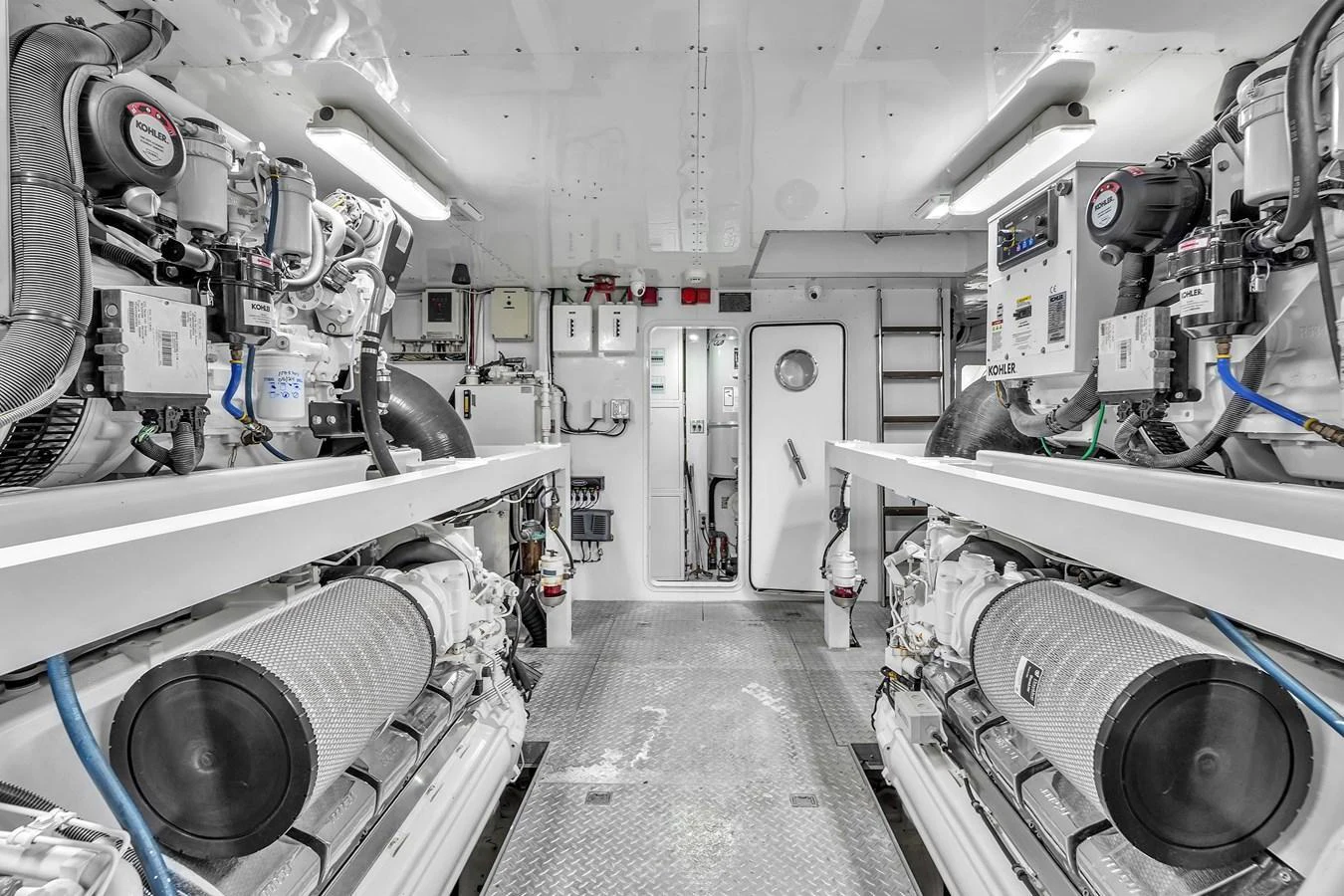 The image showcases a pristine engine room with well-organized machinery and equipment. aboard FERRETTI YACHTS CUSTOM LINE 94 Yacht for Sale