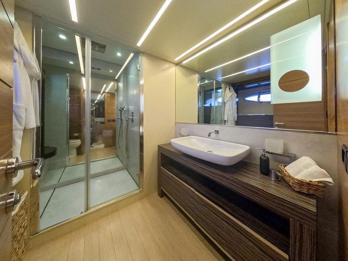A luxurious yacht bathroom featuring modern fixtures and ample lighting. aboard HONEY BADGER Yacht for Sale