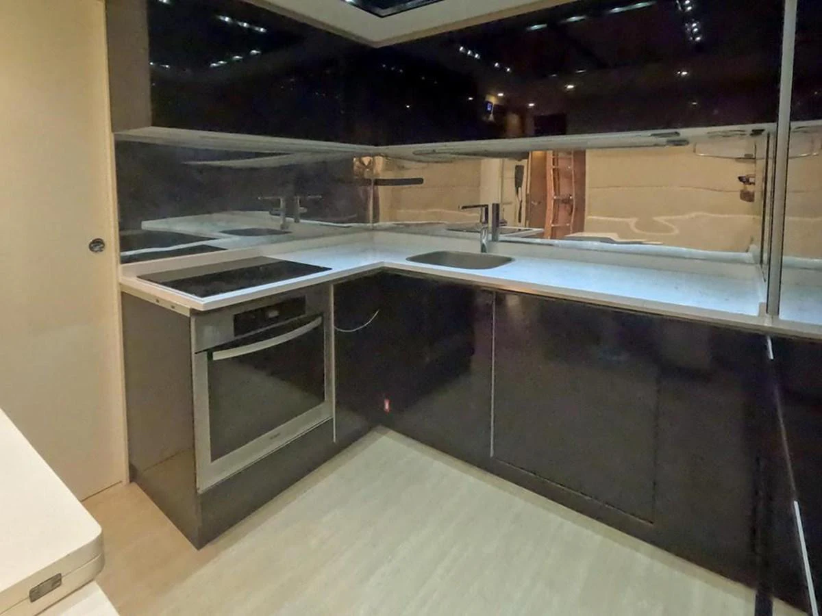 The sleek and modern galley features high-end appliances and ample counter space. aboard HONEY BADGER Yacht for Sale