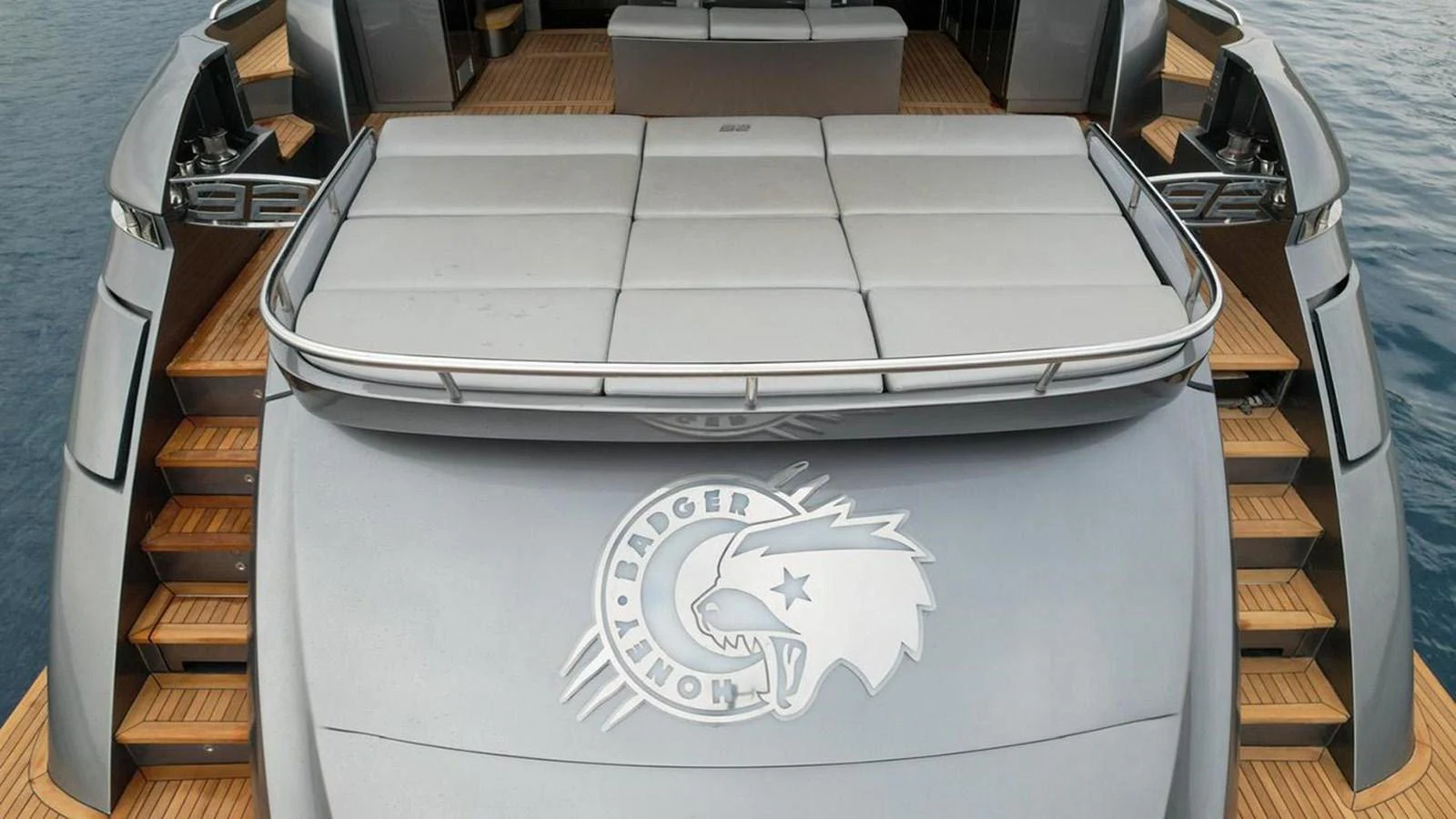 The yacht's aft deck features a spacious sunbathing area with luxurious padded loungers. aboard HONEY BADGER Yacht for Sale