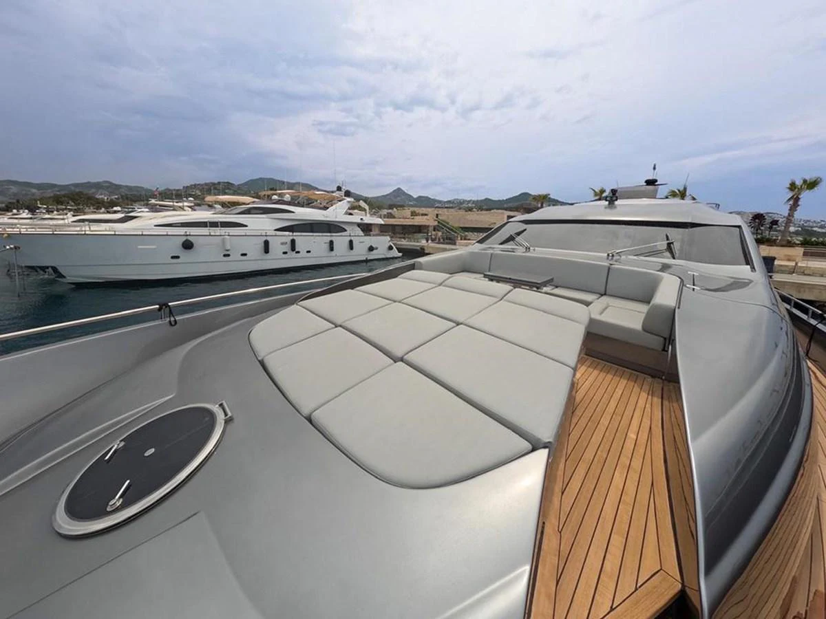 The foredeck of the yacht features a spacious sunbathing area with plush cushions and sleek design. aboard HONEY BADGER Yacht for Sale