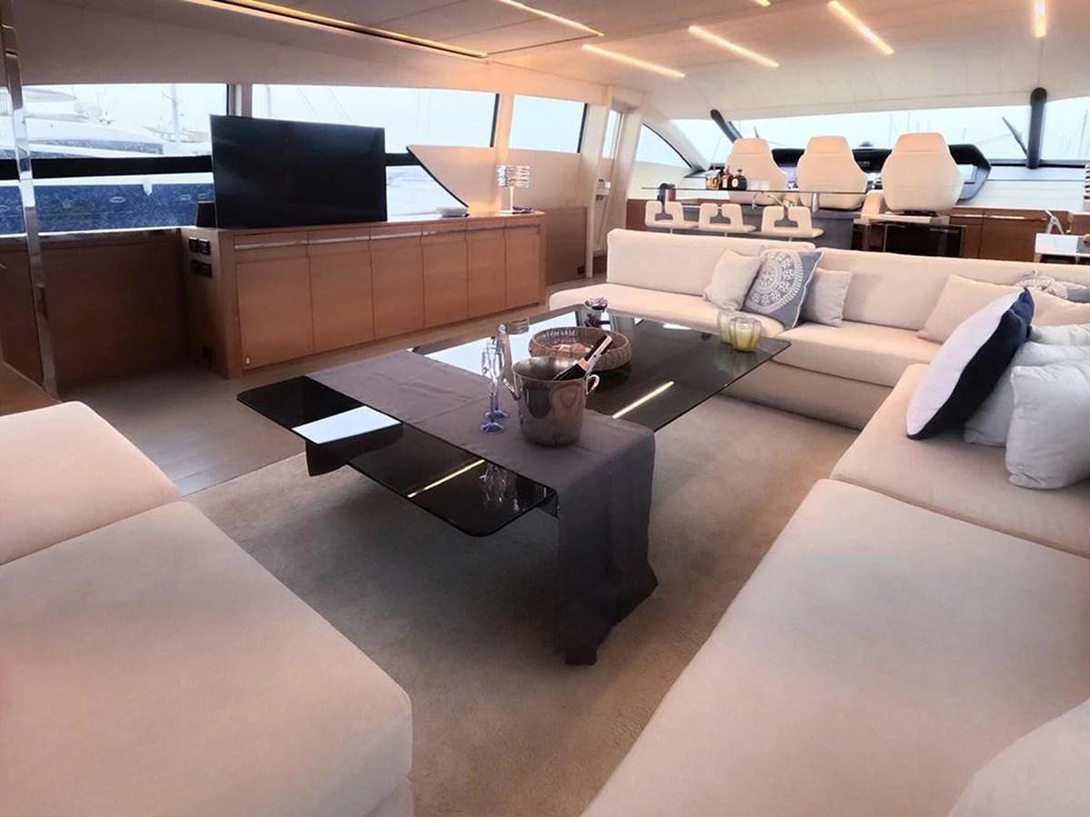 The yacht's salon features plush seating, a sleek coffee table, and large windows for natural light. aboard HONEY BADGER Yacht for Sale