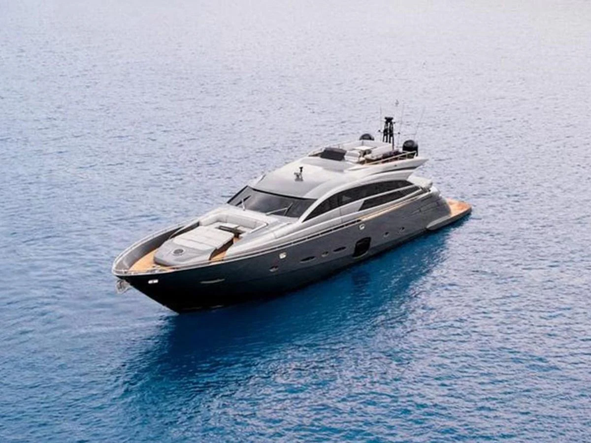 A sleek and modern yacht glides gracefully on calm blue waters. aboard HONEY BADGER Yacht for Sale