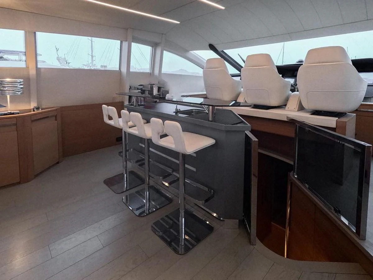 The yacht's helm area features sleek, modern seating and a stylish bar setup. aboard HONEY BADGER Yacht for Sale