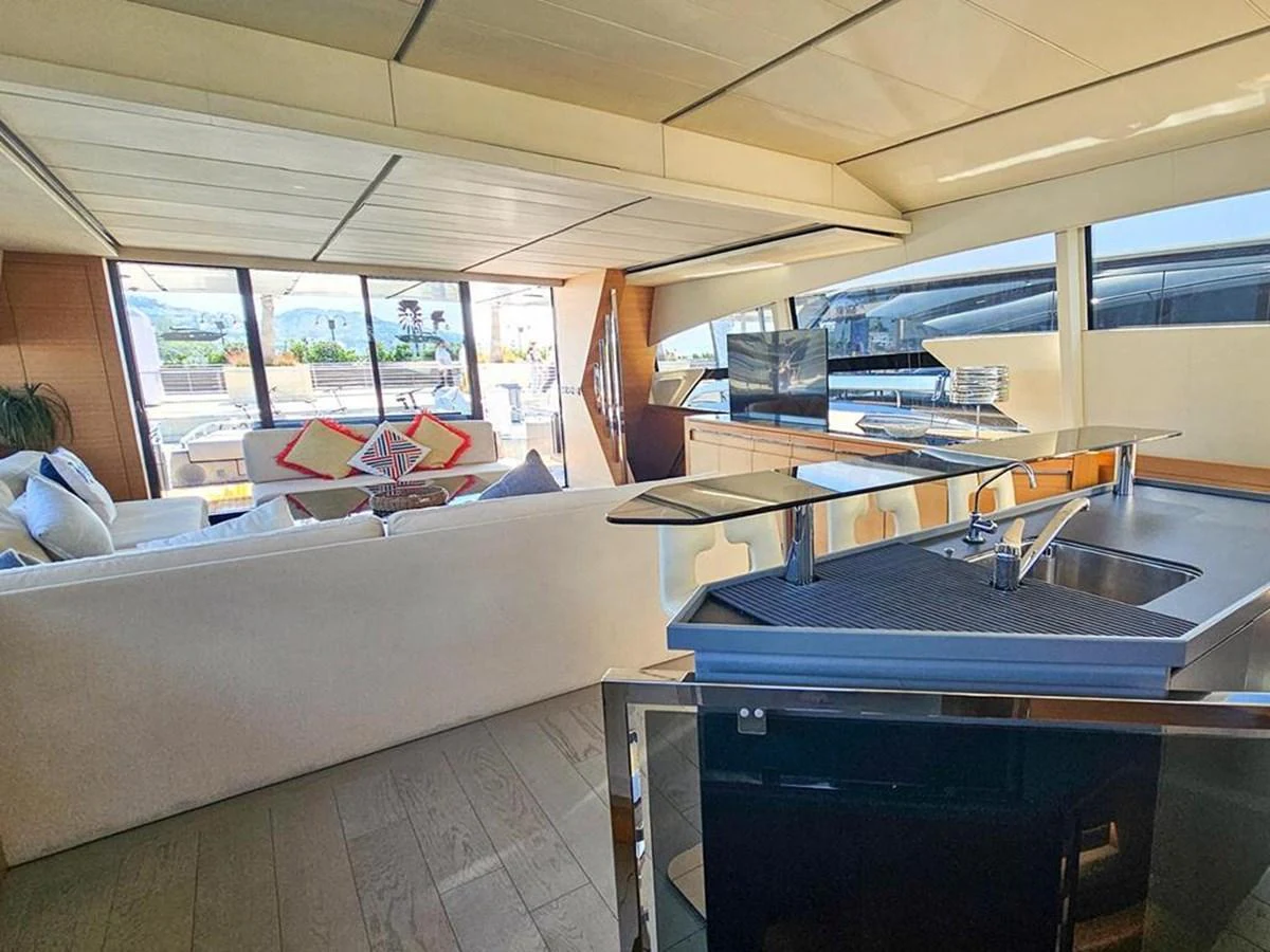 The yacht's salon features a spacious seating area with modern furnishings and large windows for natural light. aboard HONEY BADGER Yacht for Sale