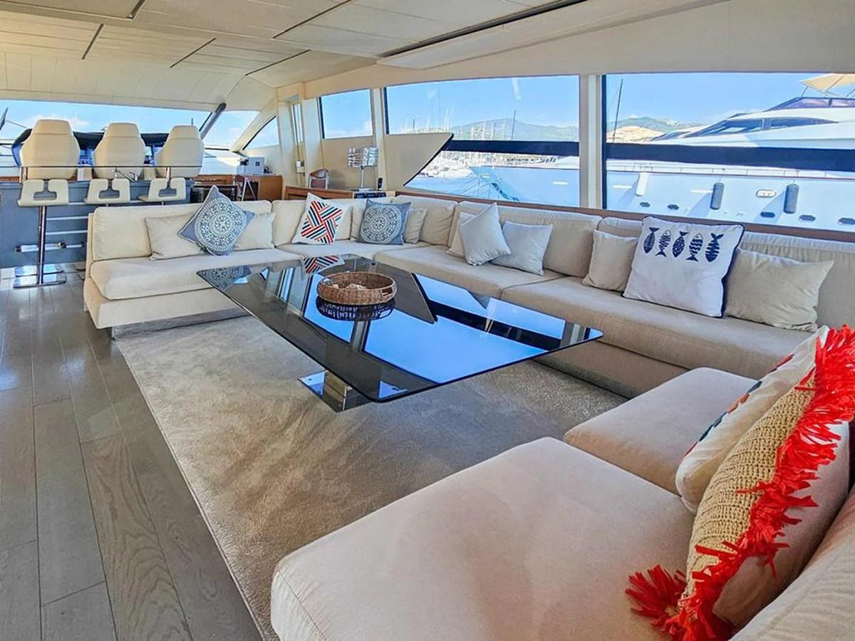 The salon features a spacious and luxurious seating area with large windows offering stunning views. aboard HONEY BADGER Yacht for Sale