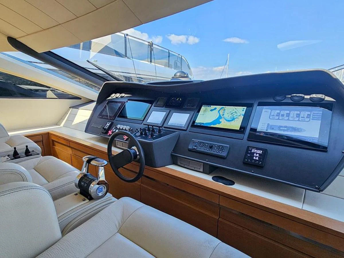 The helm station features advanced navigation systems and luxurious seating, offering a commanding view for the captain. aboard HONEY BADGER Yacht for Sale