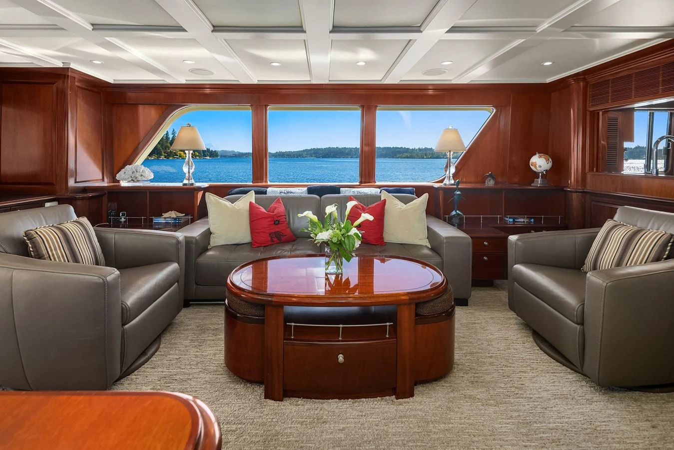 The salon features plush seating and elegant wood finishes, offering a luxurious space to relax with stunning views. aboard MI AMERE Yacht for Sale