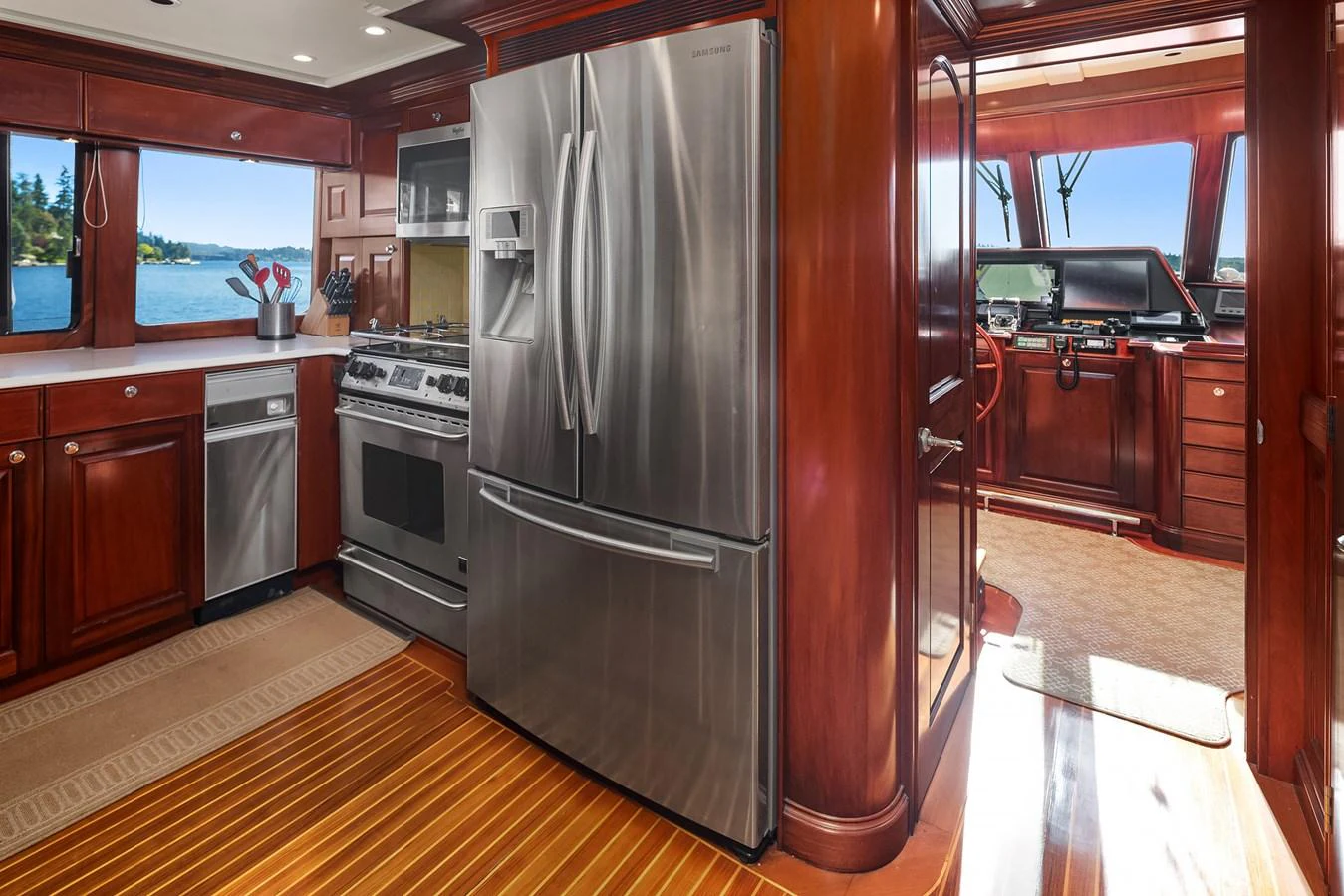 The yacht's galley features high-end stainless steel appliances and rich wooden cabinetry, offering a luxurious and functional space for meal preparation. aboard MI AMERE Yacht for Sale