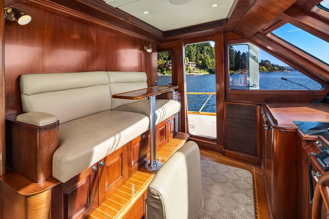 The salon features plush seating and large windows offering stunning water views. aboard MI AMERE Yacht for Sale