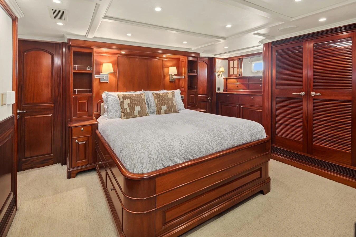 The master stateroom features elegant wood finishes and a spacious bed. aboard MI AMERE Yacht for Sale