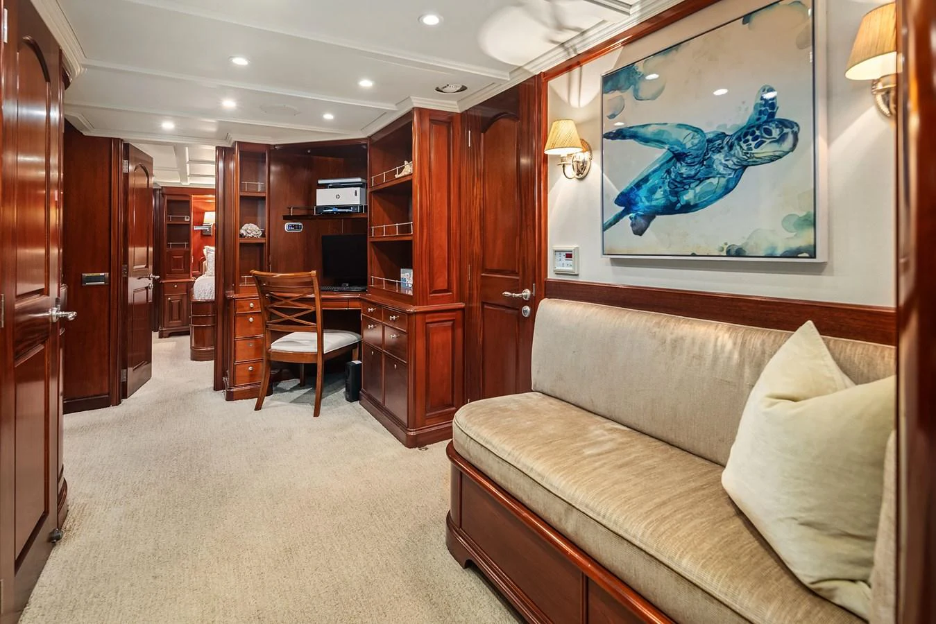 The yacht's interior features a cozy seating area with rich wood paneling and elegant decor. aboard MI AMERE Yacht for Sale