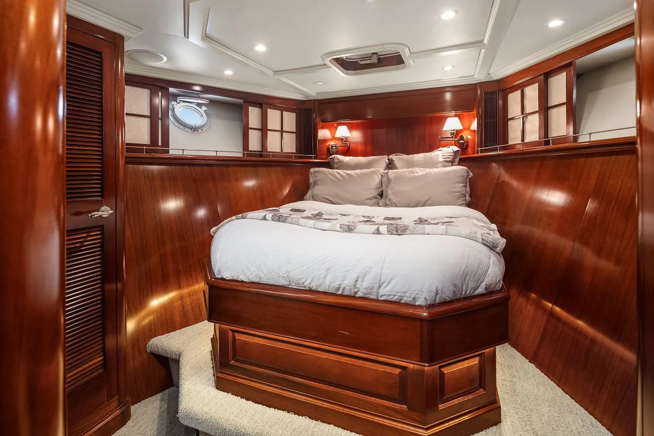 This cozy stateroom features rich wood paneling and a comfortable bed, creating a warm and inviting atmosphere. aboard MI AMERE Yacht for Sale
