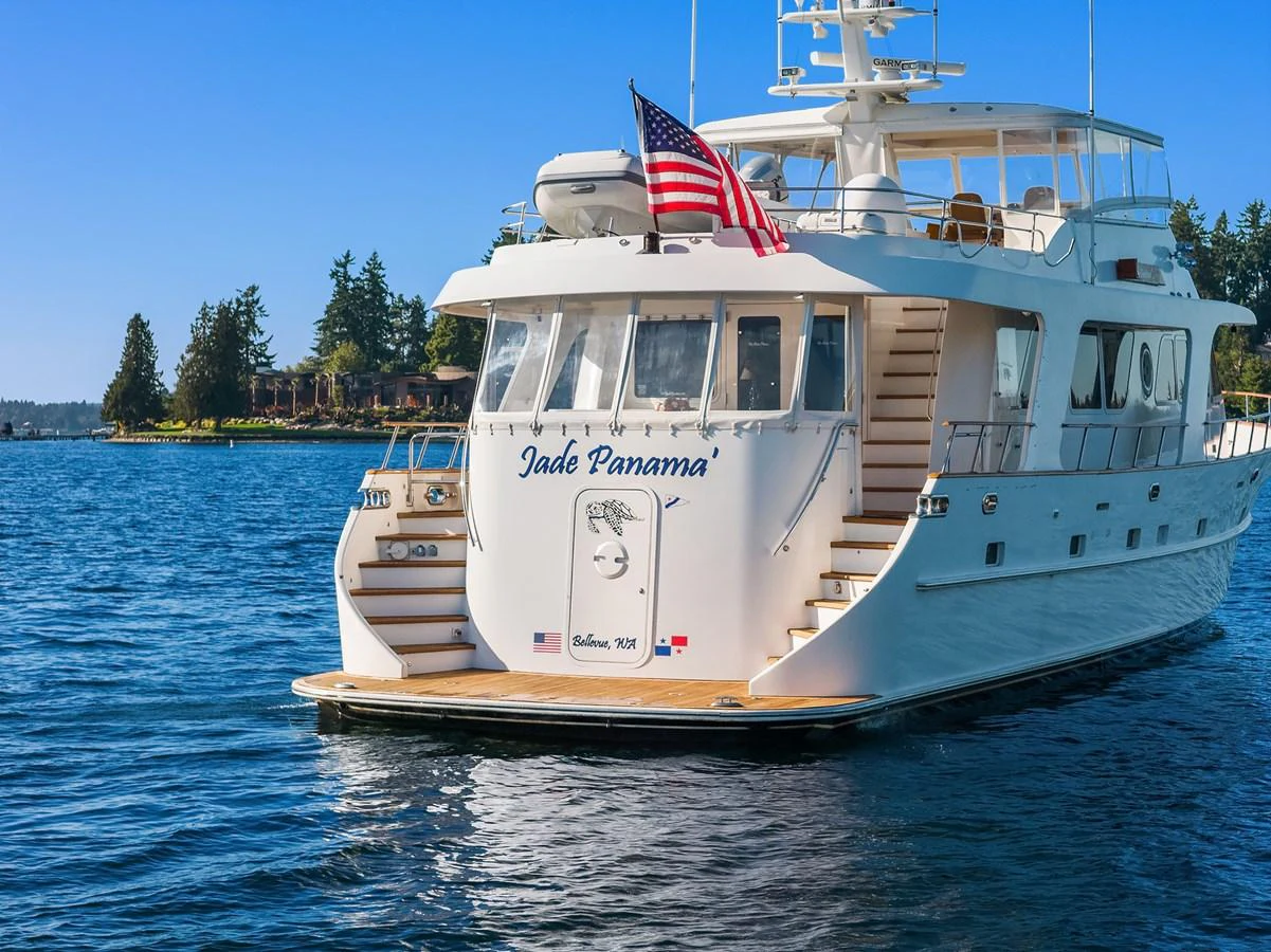 A luxurious yacht with a spacious aft deck cruising on serene waters. aboard MI AMERE Yacht for Sale