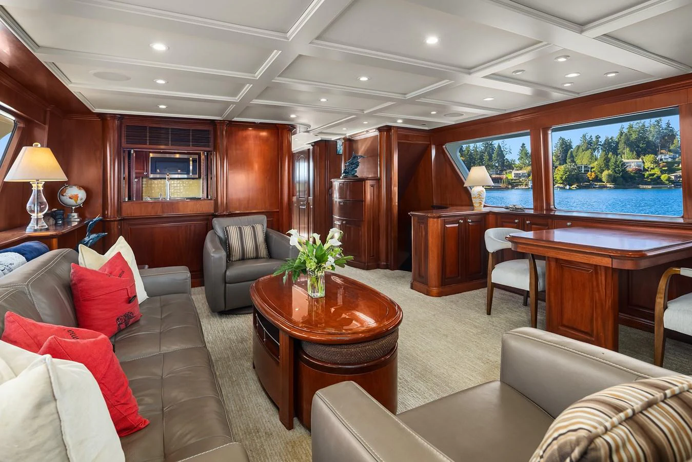 The salon features elegant wood finishes, plush seating, and large windows offering scenic views. aboard MI AMERE Yacht for Sale