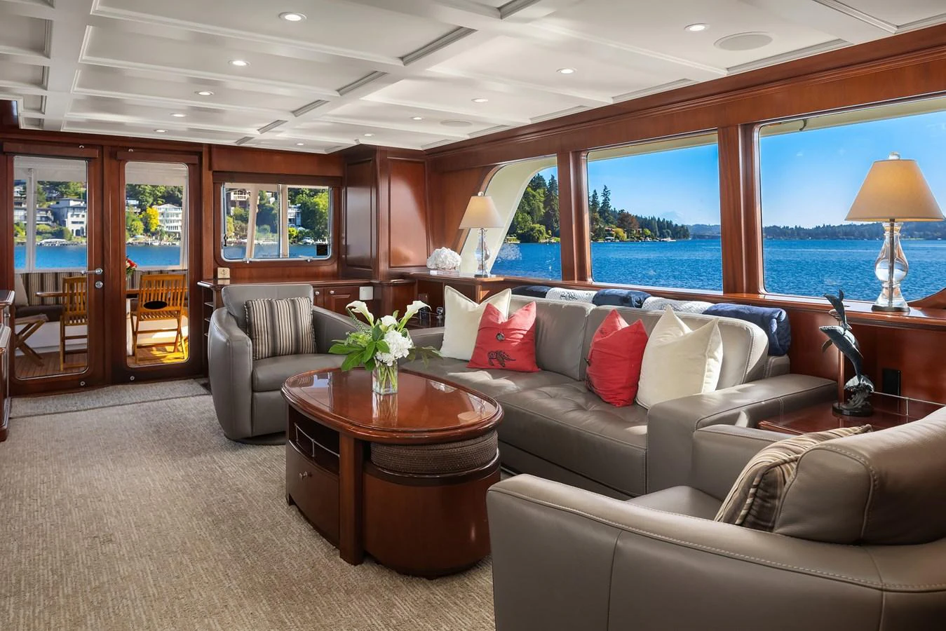 The salon offers a luxurious and comfortable space with large windows providing stunning views of the water. aboard MI AMERE Yacht for Sale