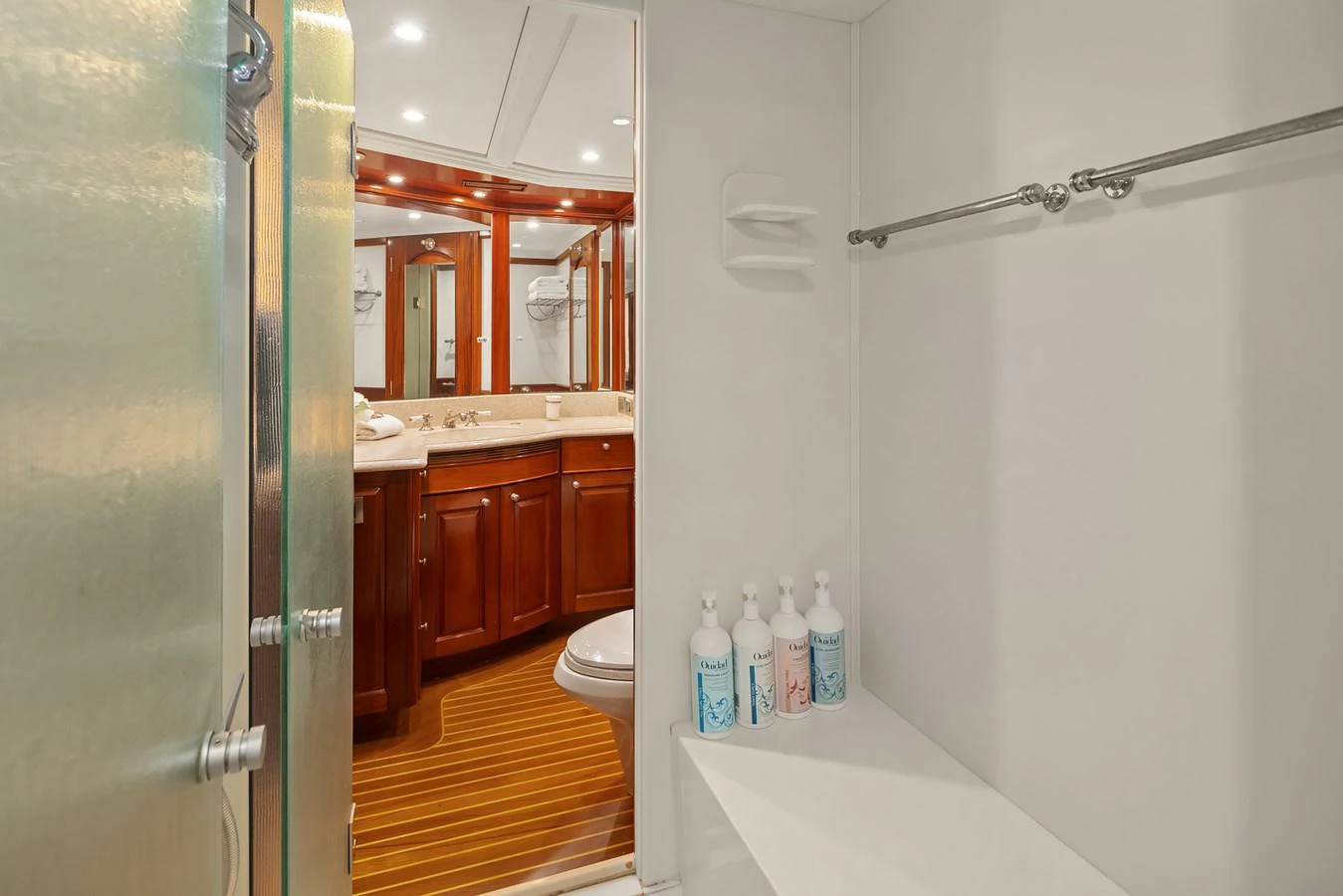 The yacht's bathroom features a sleek design with wooden cabinetry and modern fixtures. aboard MI AMERE Yacht for Sale