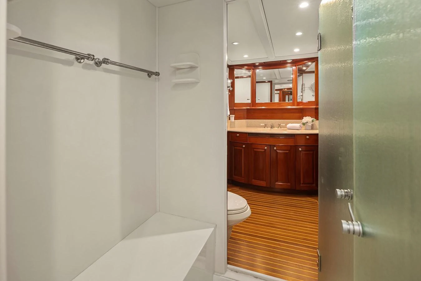 The yacht's bathroom features elegant wooden cabinetry and modern fixtures. aboard MI AMERE Yacht for Sale