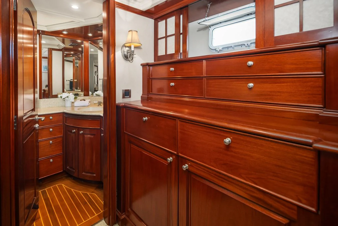 The yacht's cabin features elegant wooden cabinetry and a well-appointed vanity area. aboard MI AMERE Yacht for Sale