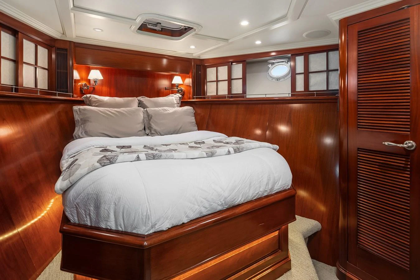 A cozy stateroom with a plush bed and warm wooden finishes. aboard MI AMERE Yacht for Sale