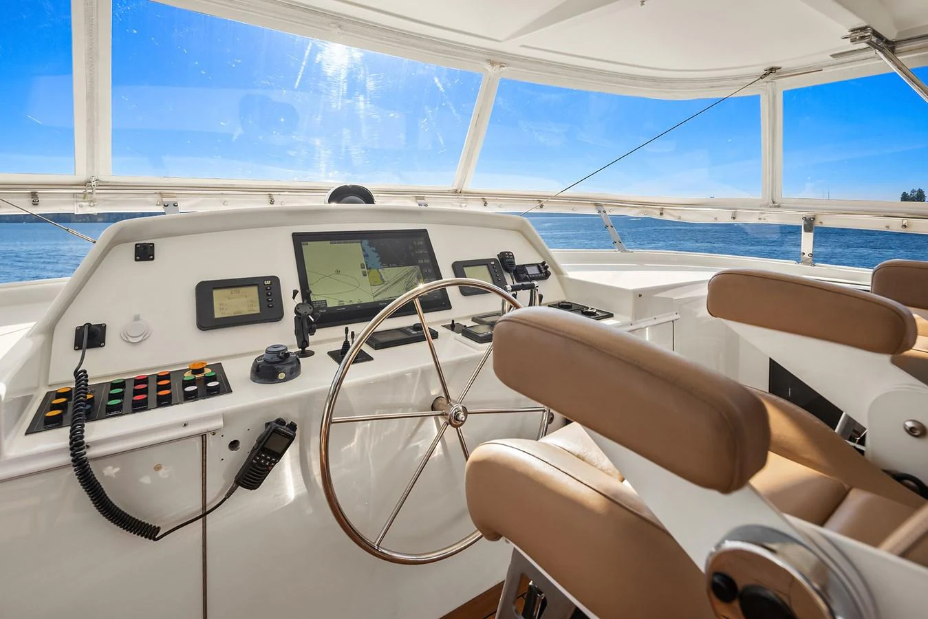The helm station offers a commanding view with modern navigation equipment and comfortable seating. aboard MI AMERE Yacht for Sale