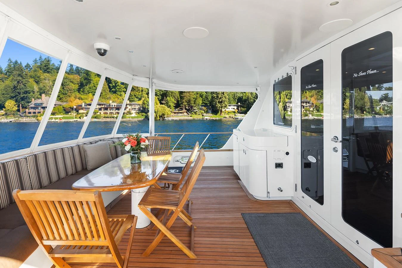 The aft deck features a comfortable dining area with a scenic view. aboard MI AMERE Yacht for Sale