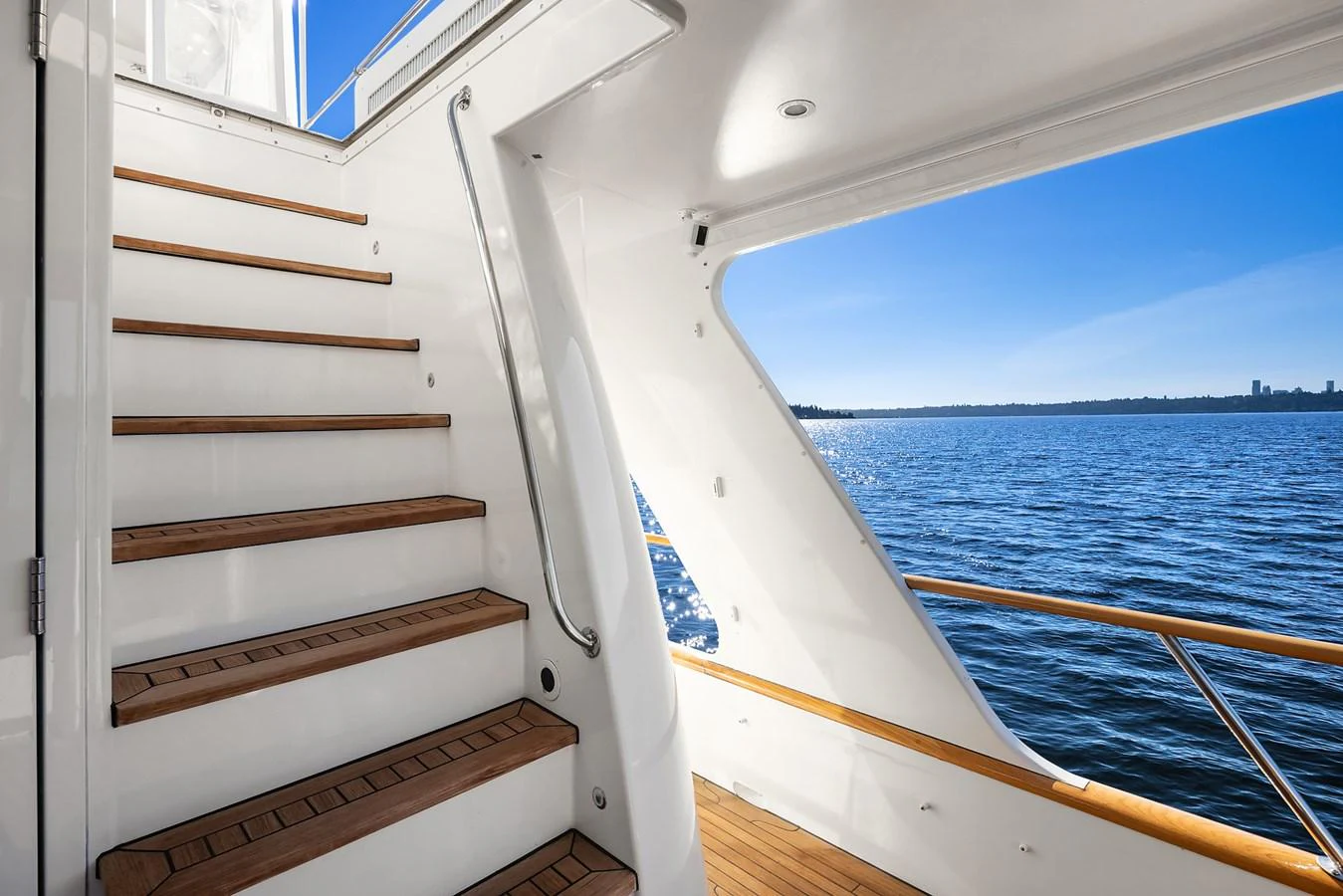 A sleek staircase leads to the upper deck, offering stunning views of the water. aboard MI AMERE Yacht for Sale