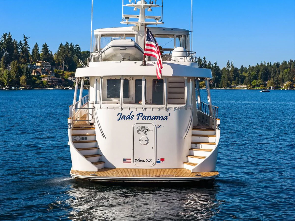 The yacht is seen from the rear, showcasing its elegant design and inviting deck area. aboard MI AMERE Yacht for Sale