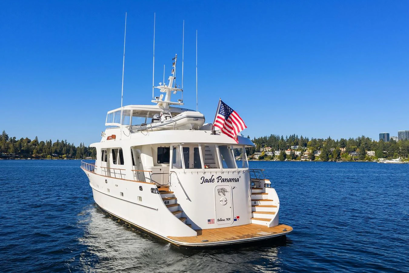 A pristine yacht cruises on calm waters under a clear blue sky. aboard MI AMERE Yacht for Sale