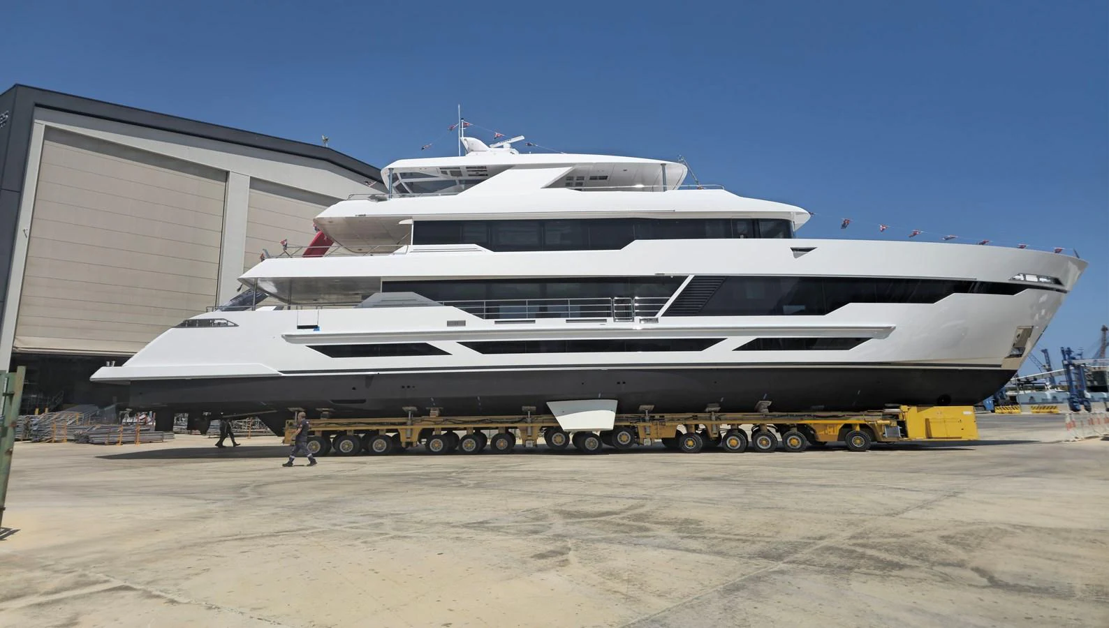 A sleek, modern yacht is showcased on a trailer, highlighting its impressive size and design. aboard E SERIES 125 HARGRAVE SUPERYACHTS Yacht for Sale