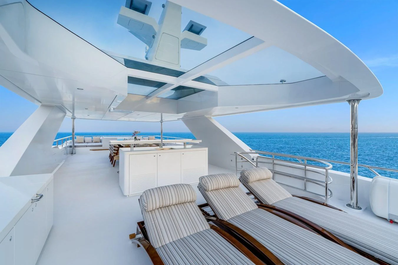 The sundeck features luxurious lounge chairs and a spacious, open-air design with stunning ocean views. aboard E SERIES 125 HARGRAVE SUPERYACHTS Yacht for Sale