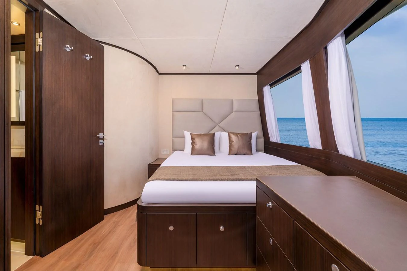 The stateroom features a plush bed with a serene ocean view through large windows. aboard E SERIES 125 HARGRAVE SUPERYACHTS Yacht for Sale