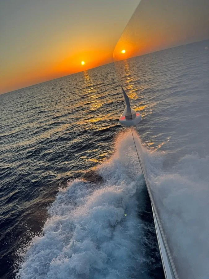 A stunning sunset view from the side of a yacht cutting through the waves. aboard E SERIES 125 HARGRAVE SUPERYACHTS Yacht for Sale