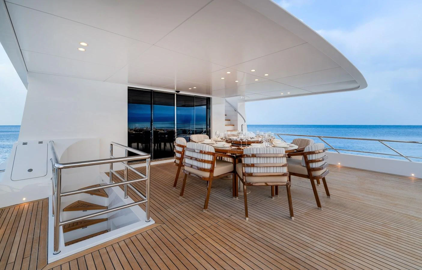 The aft deck features an elegant dining area with a stunning ocean view. aboard E SERIES 125 HARGRAVE SUPERYACHTS Yacht for Sale