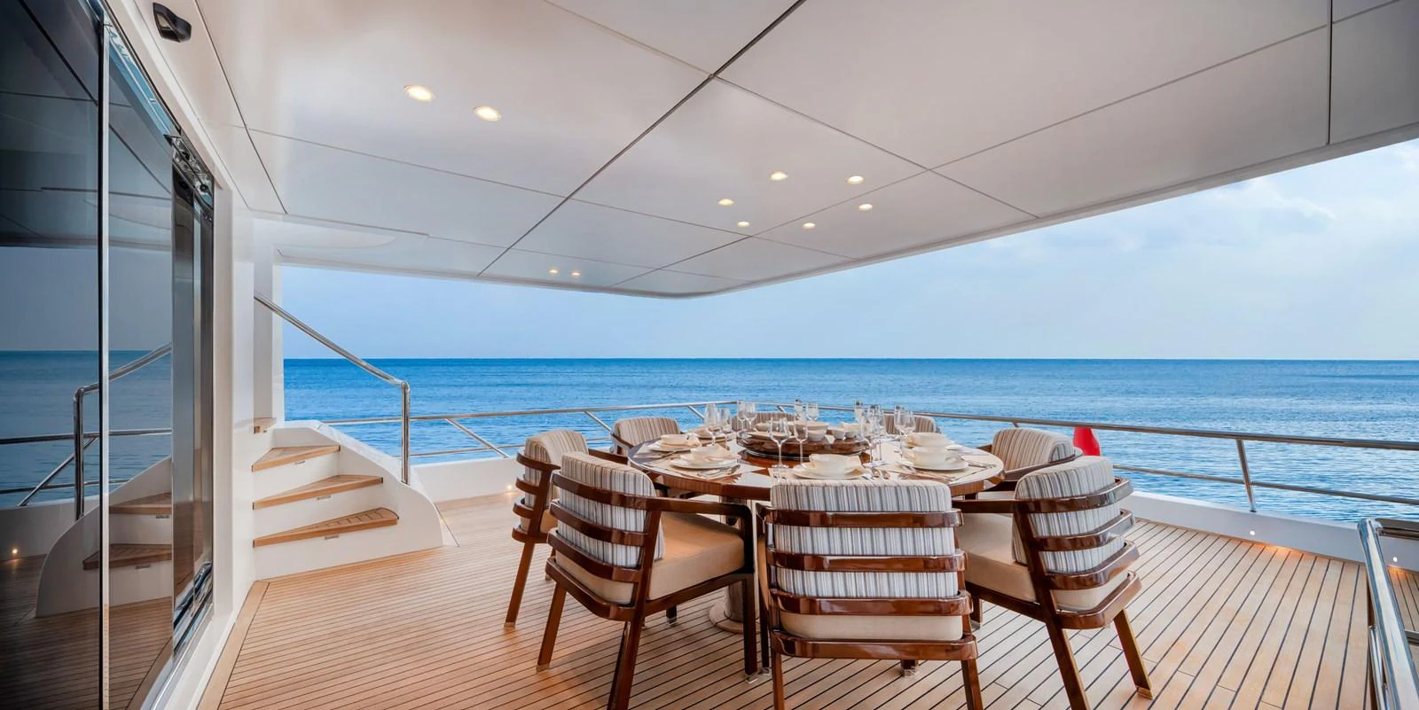 The aft deck offers a luxurious dining area with stunning ocean views. aboard E SERIES 125 HARGRAVE SUPERYACHTS Yacht for Sale